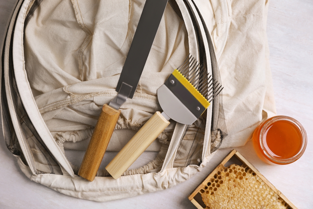 Different,Beekeeping,Tools,And,Jar,Of,Honey,On,White,Table,