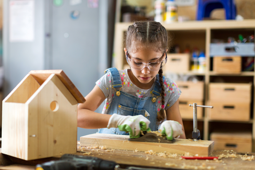 Girl,Building,Birdhouse,In,Garage