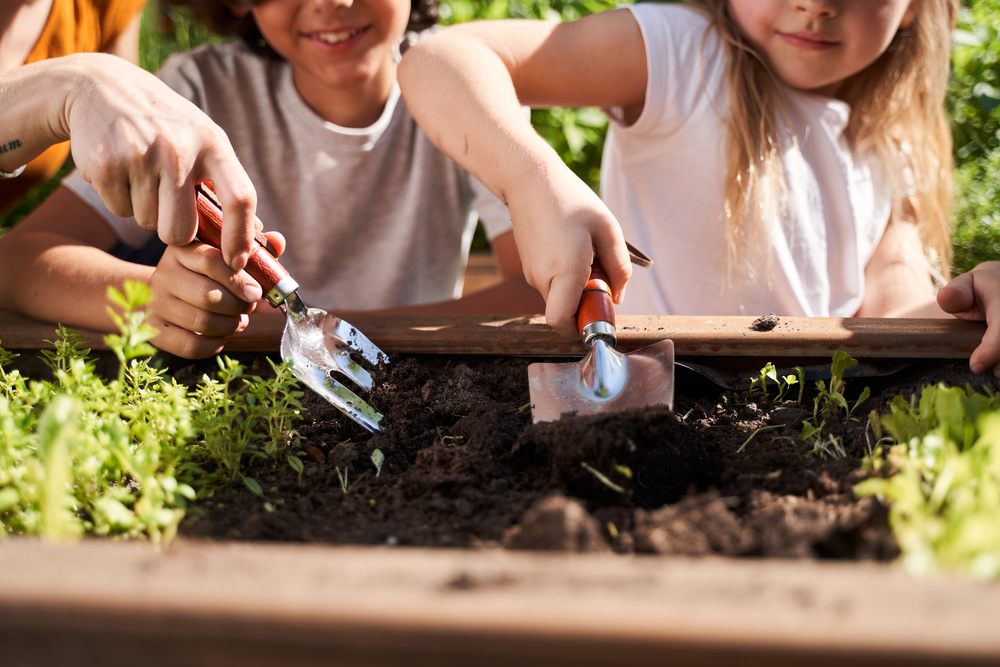 Close,Up,Of,Adorable,Kids,Using,Garden,Instruments,While,Planting